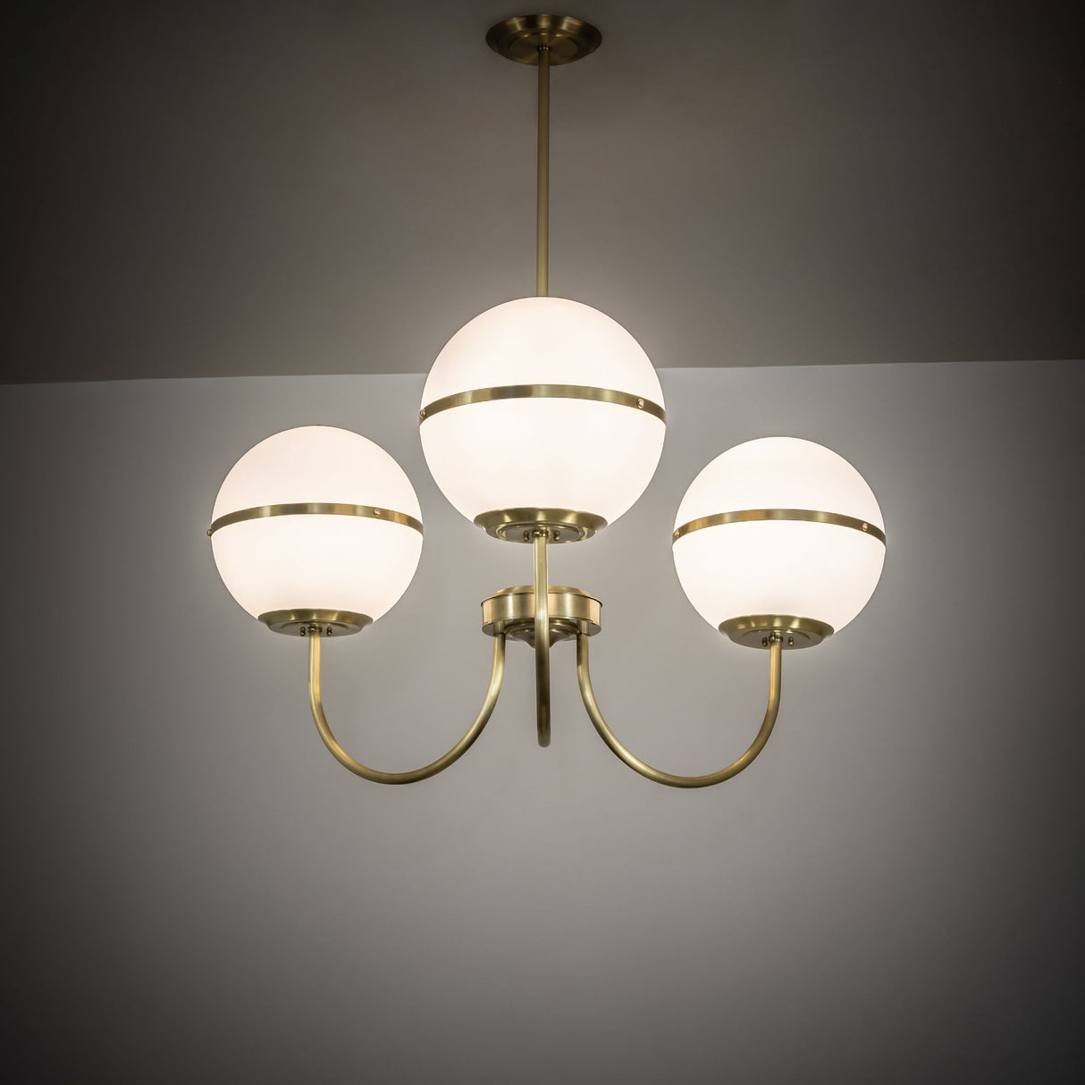 Toccata chandelier illuminated in ambient room setting.