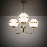 Toccata chandelier illuminated in ambient room setting.