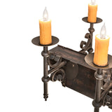 Detail view of ivory faux candlelight with metal bobeche on Tudor chandelier.