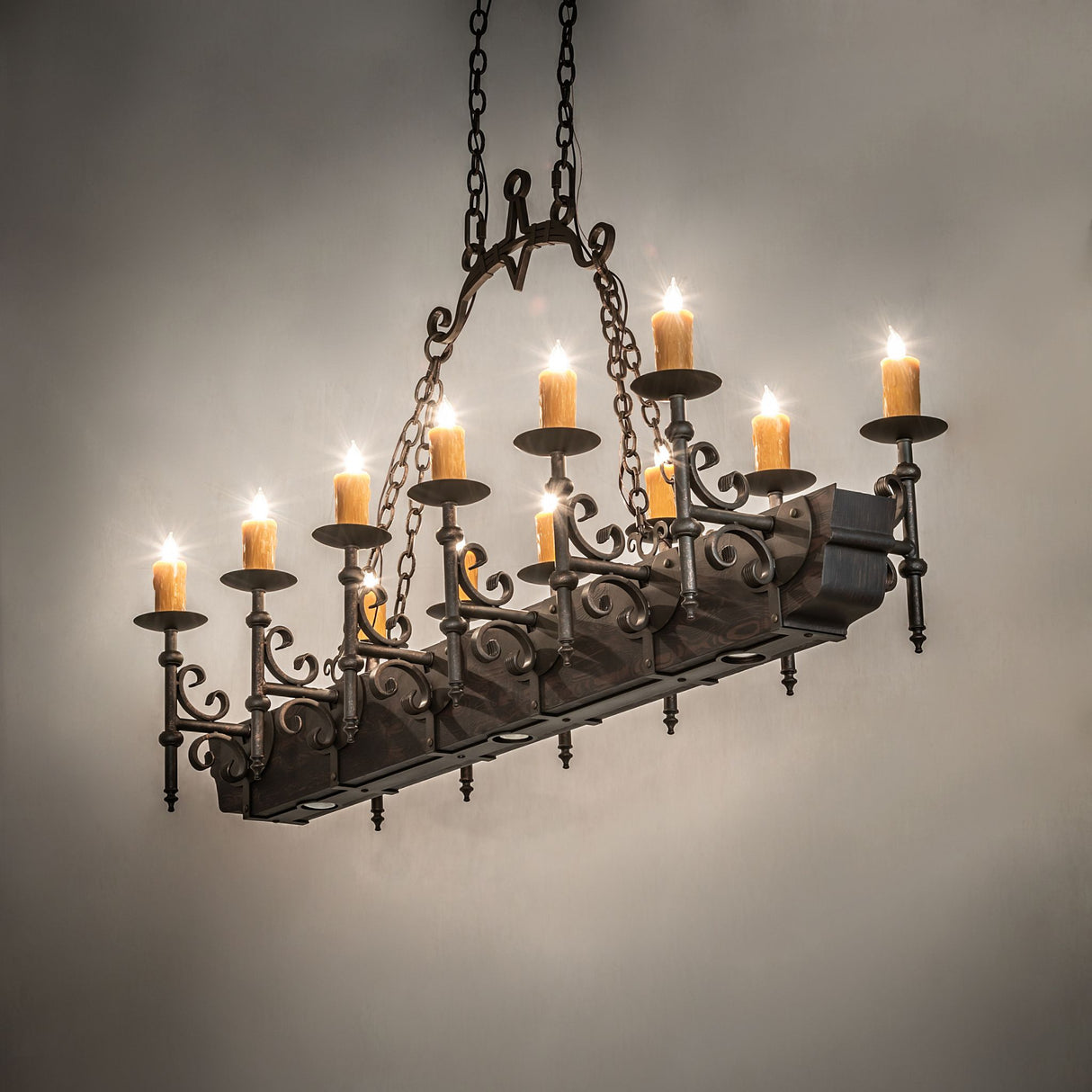 Candlelight lit view of chandelier highlighting warm faux candle glow and Gothic styling.