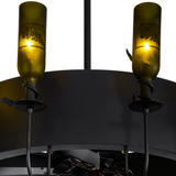 Closeup lit view showing grape-etched bottle and wrought iron detail.
