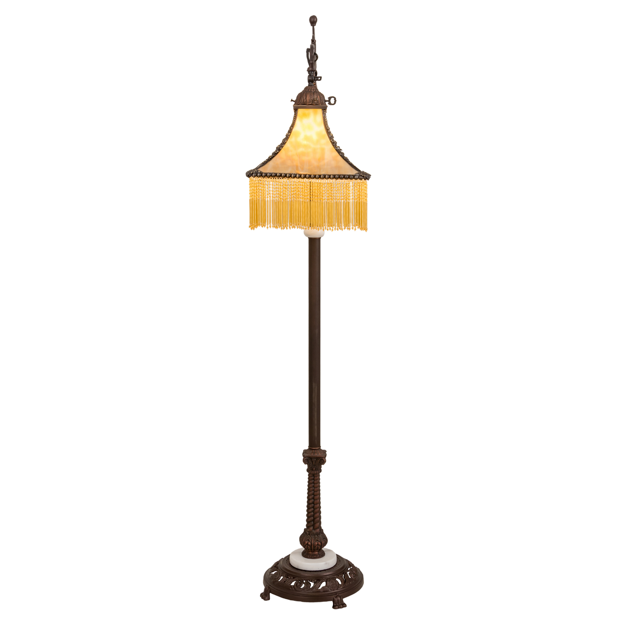Front lit view of Victorian floor lamp with glowing amber glass.