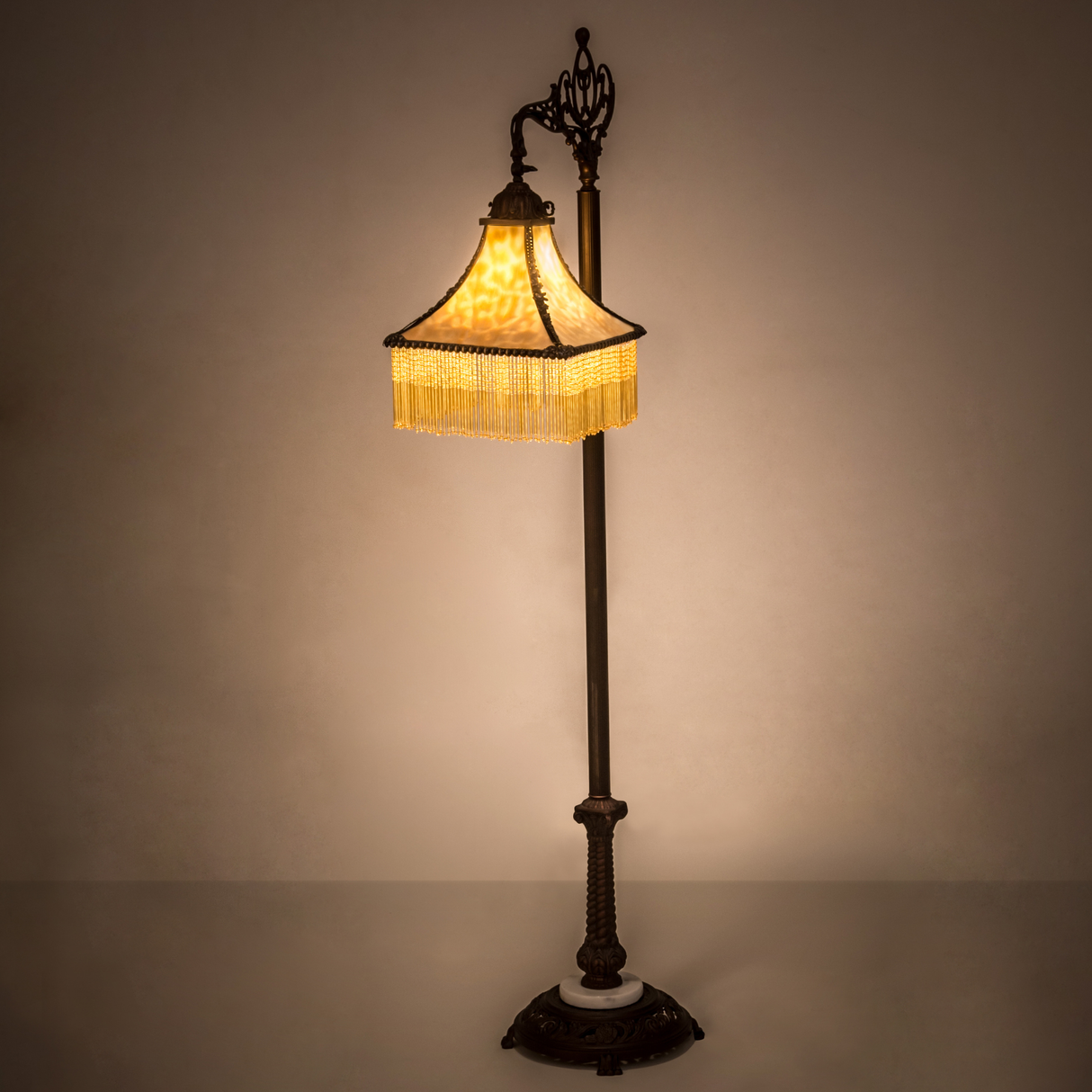 Victorian bridge arm floor lamp glowing in warm ambiance setting.