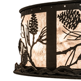 Close-up of illuminated mica shade showing handcrafted pinecone and branch pattern.