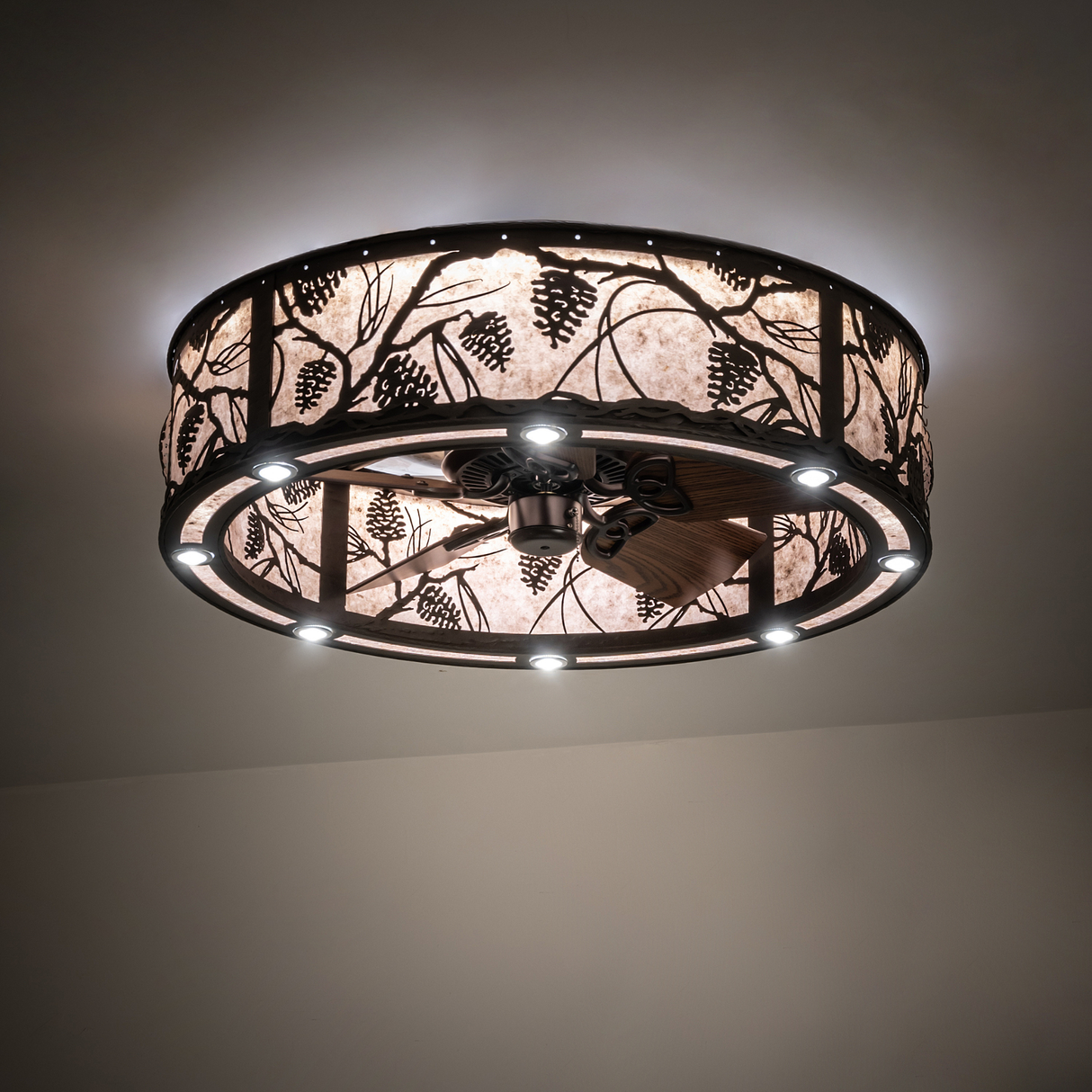 Whispering Pines chandelier fan softly lit against neutral ceiling.