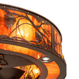 Close-up showing handcrafted pinecone and branch details on Whispering Pines fixture.