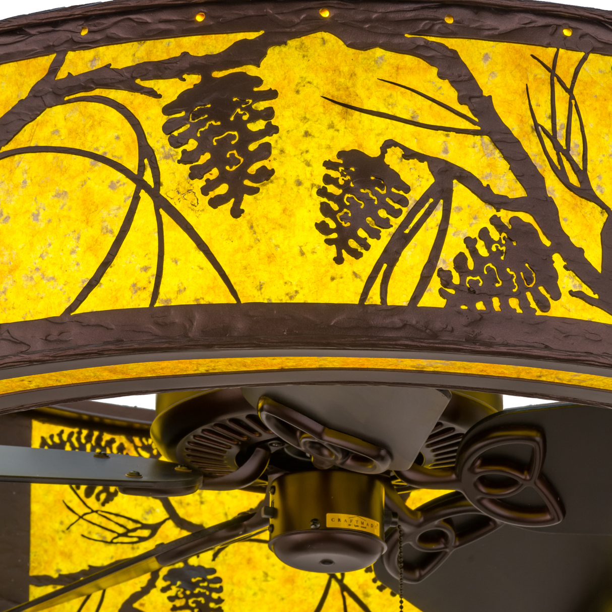 Closeup of pinecone detailing and illuminated amber mica diffuser.