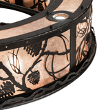 Close-up of metal frame with textured wrought iron pine branch accents.