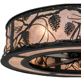 Close-up lit view showcasing detailed pinecone cutouts and glowing mica texture.