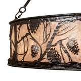 Close-up of silver mica panel with pinecone and branch cutout detail.