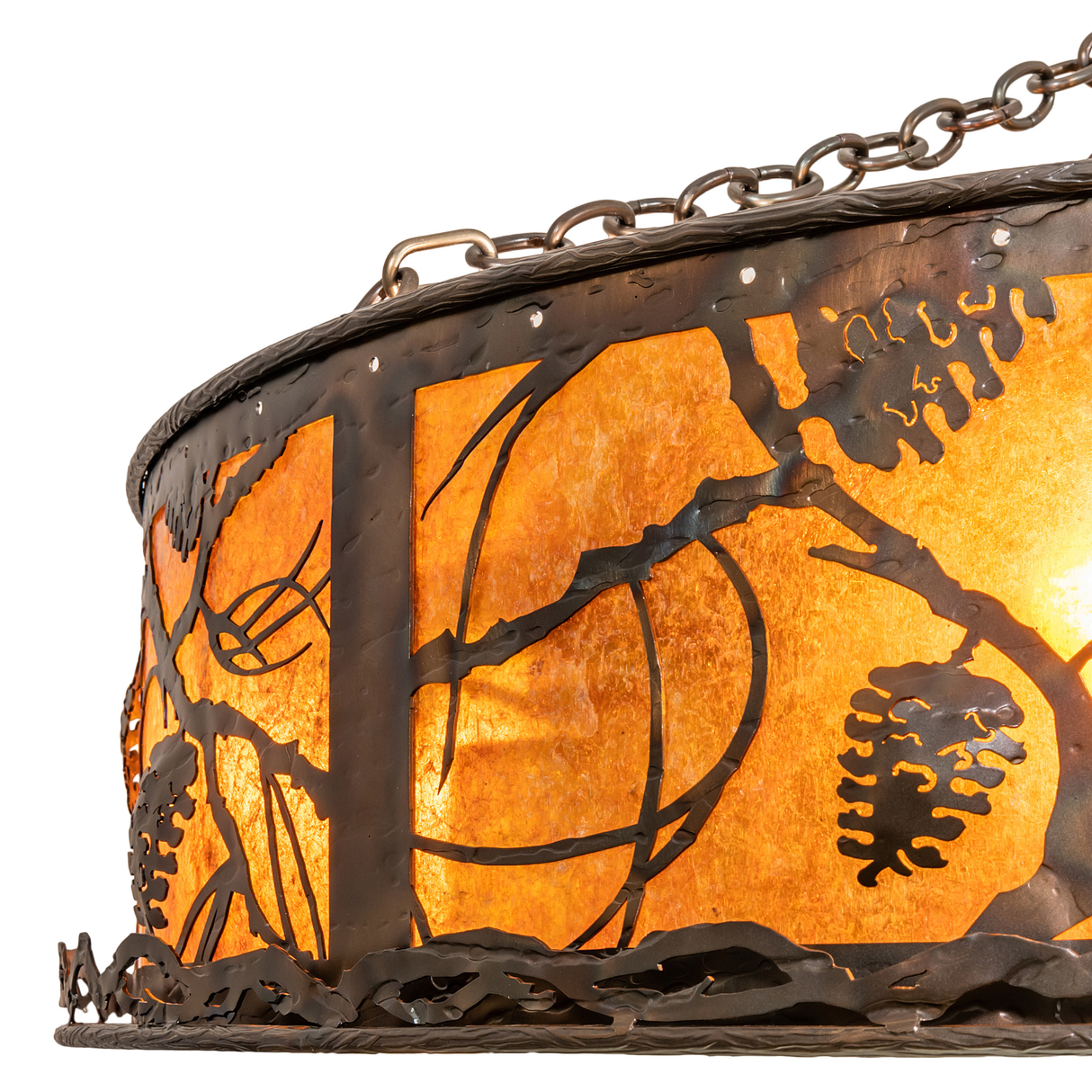Closeup of handcrafted metal pinecone pattern and mica shade texture.