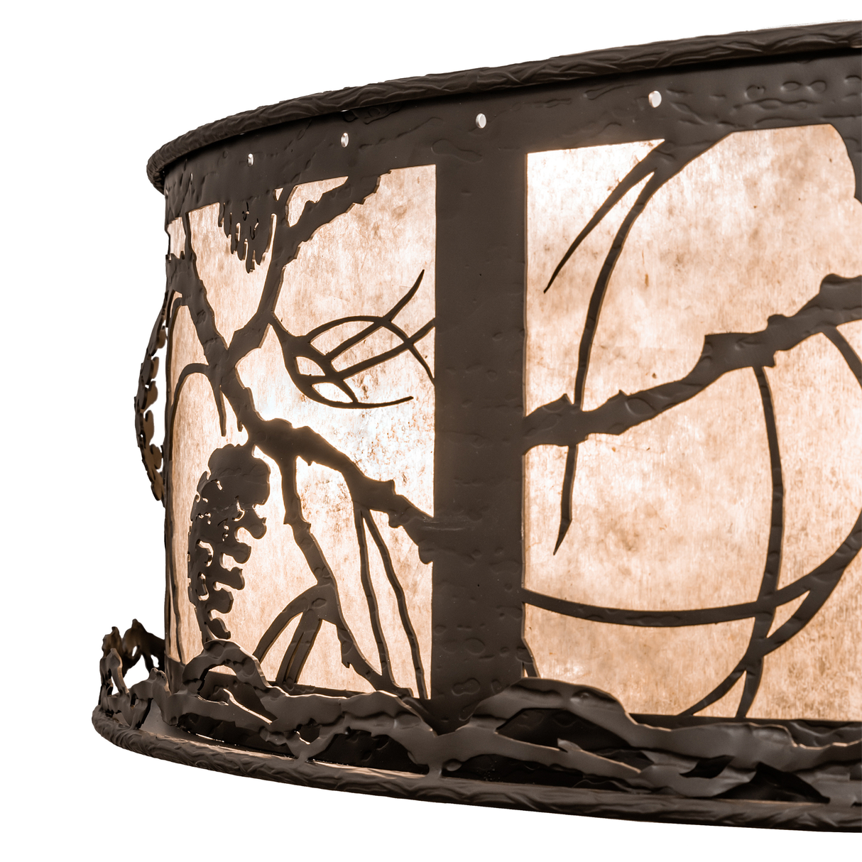 Closeup showing fan blades and mica shade texture with decorative pine motif.