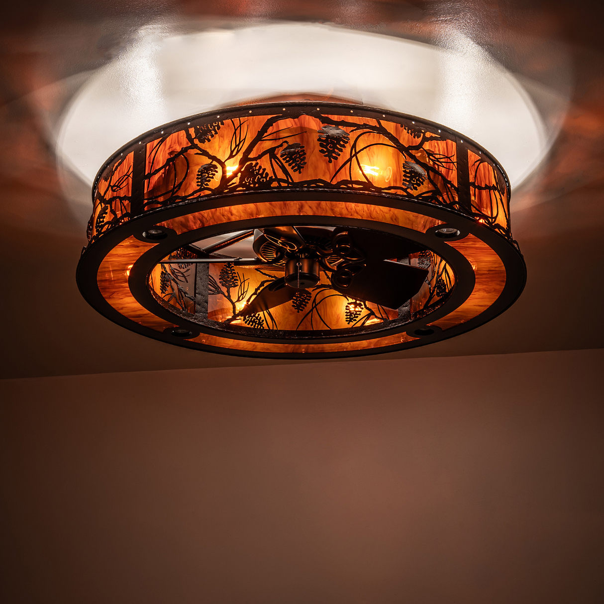 Whispering Pines chandelier glowing warmly with amber diffuser.