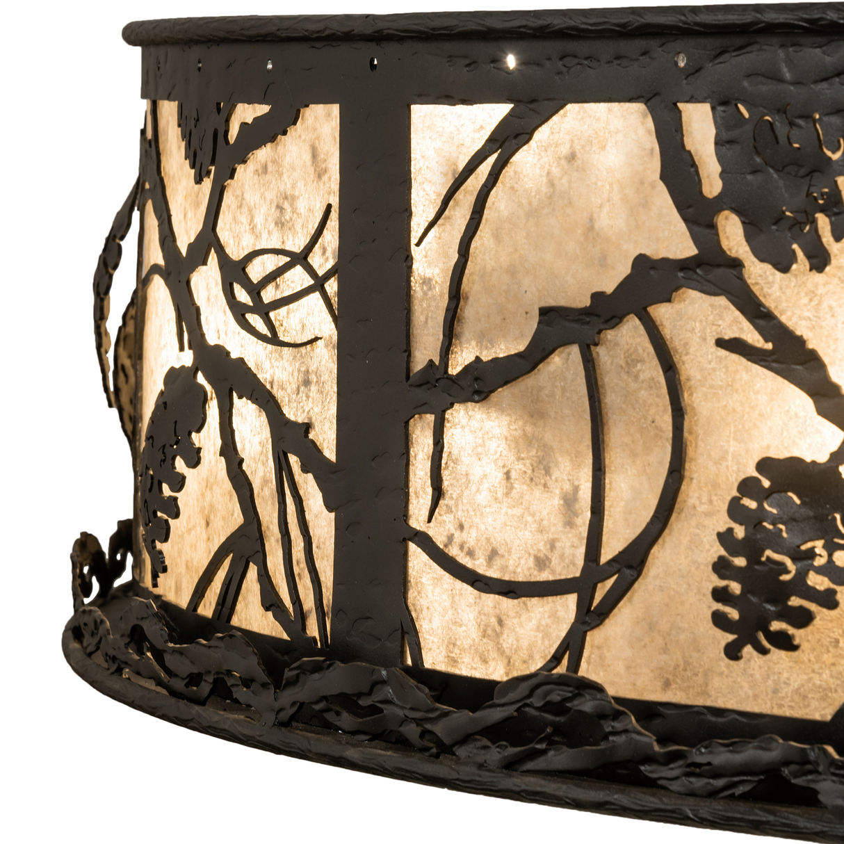 Detail view of pinecone and branch cutouts over softly glowing mica panels.