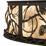 Detail view of pinecone and branch cutouts over softly glowing mica panels.