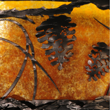 Pinecone detail close-up showing textured bronze overlay.