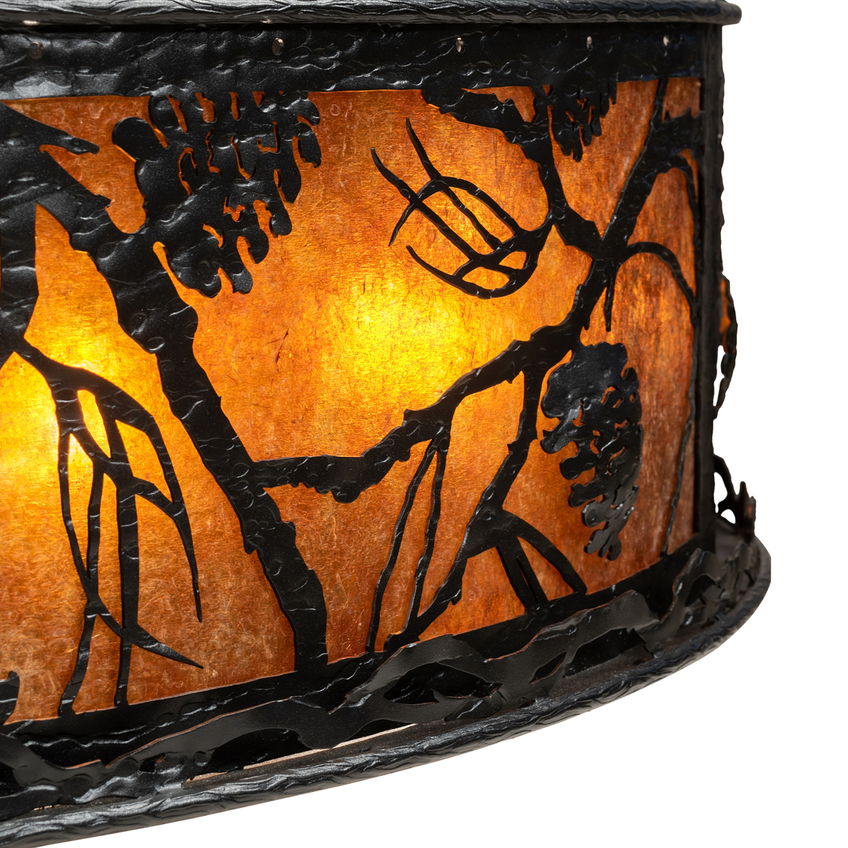 Close-up of glowing amber mica shade with detailed pinecone metal design.