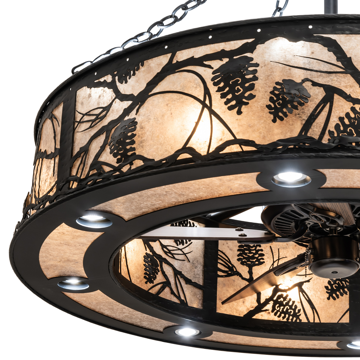 Close-up of Whispering Pines Chandel-Air shade with backlit pine motif.