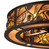 Close-up of pinecone metalwork and amber mica on Whispering Pines Chandel-Air.