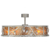 Side lit view showing intricate pinecone cutouts and soft amber light.
