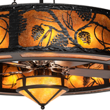 Close-up of handcrafted pine branch metalwork over amber mica shade.
