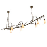 Lit view of chandelier with branch-style metal frame and glowing silver mica shades.