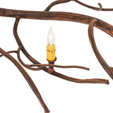 Detailed close-up highlighting driftwood brown finish branch texture and candlelight.
