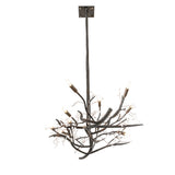 Angled view of chandelier emphasizing branching silhouette and candle lights.