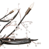 Close-up of chandelier branches with crystal bud accents and candle-style sockets.