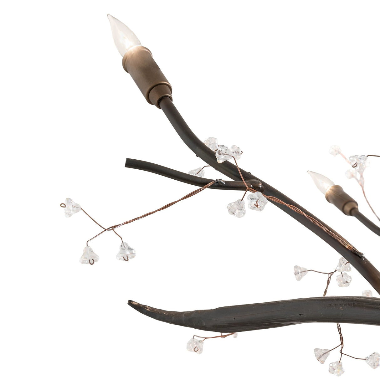 Detailed view of candle-style bulb and sculpted metal branch on chandelier.
