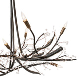 Close-up detail of chandelier branches with crystal buds and candle socket.