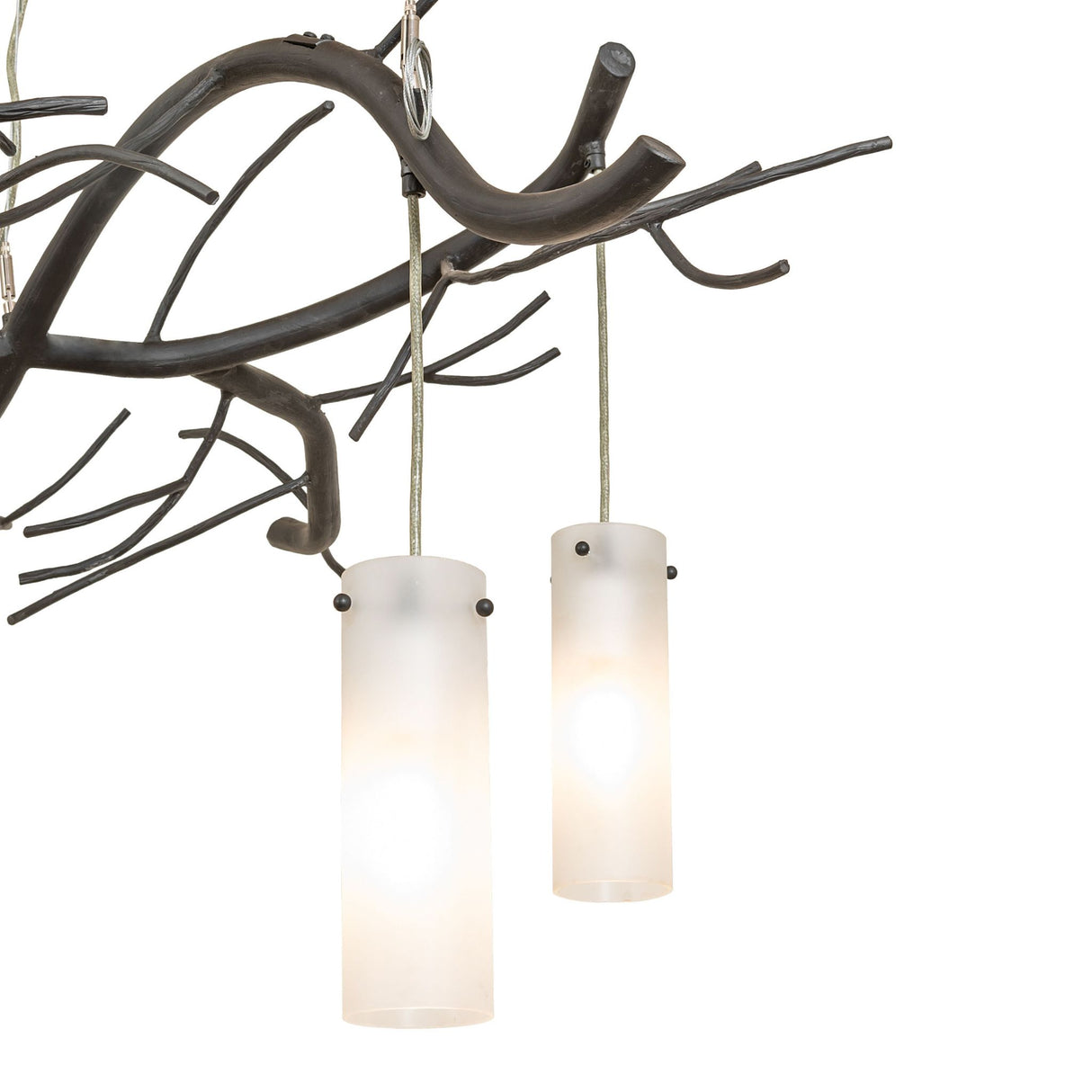 Close-up of frosted cylindrical glass shades softly diffusing light for ambient illumination.