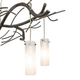 Close-up of frosted cylindrical glass shades softly diffusing light for ambient illumination.